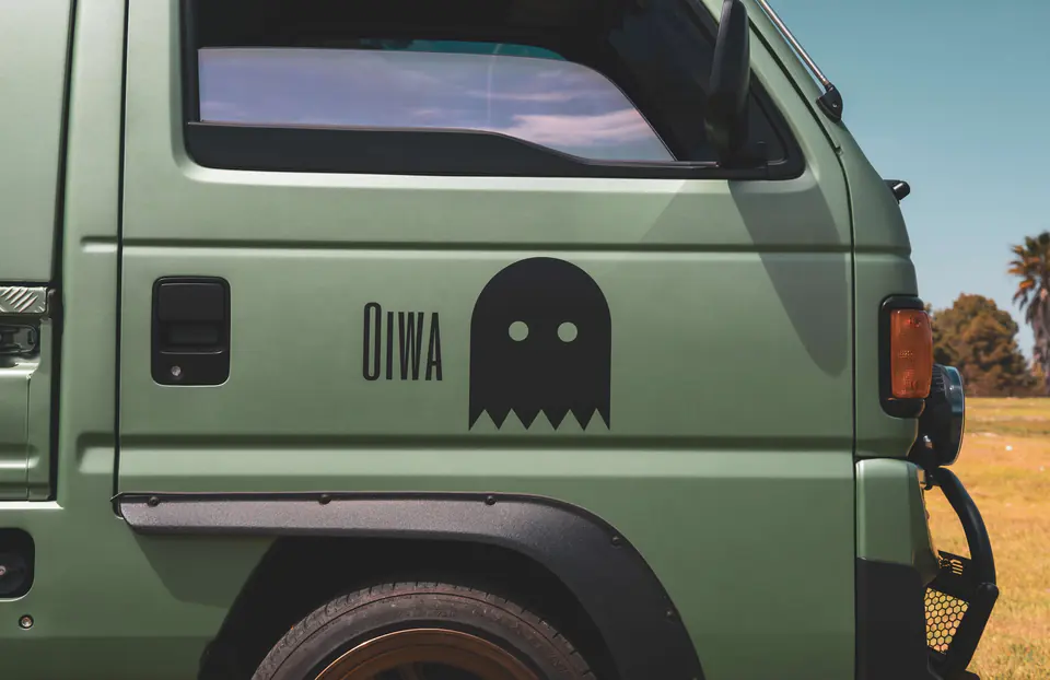 Oiwa Garage ghost logo on the side of a green Honda Acty camper build