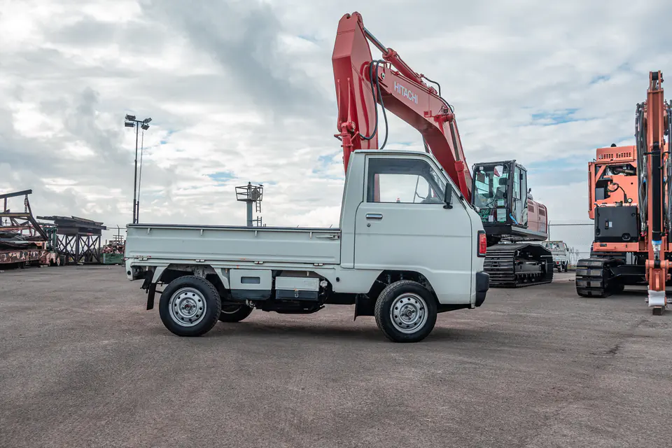 Vintage Honda Acty 4WD Kei Truck at a construction yard next to an excavator